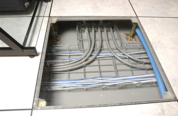 ASM clear raised floor tile in the data center showing wiring below