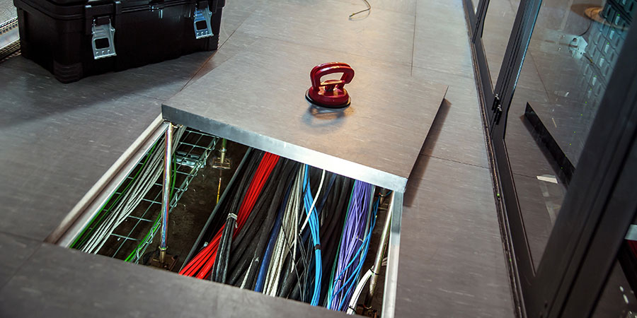 cable management under raised tile floor in a data center